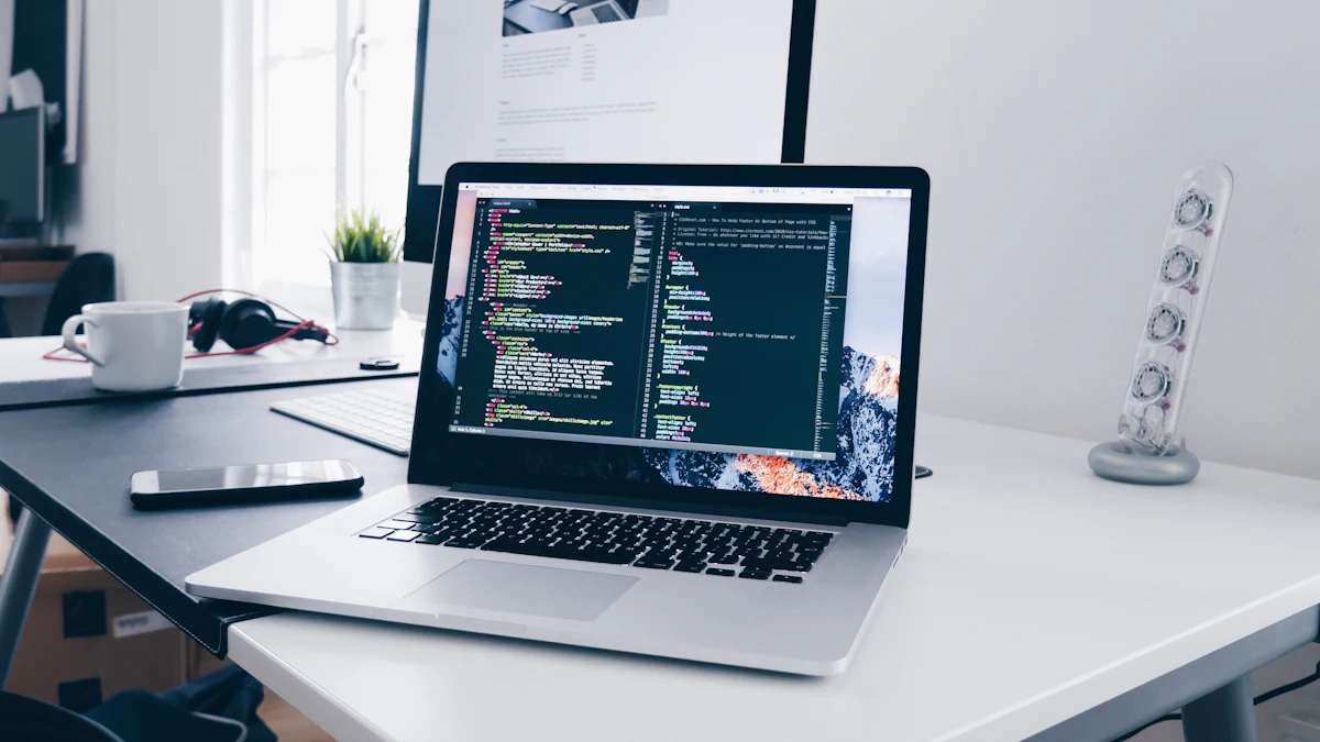 Laptop showing website code on a bright desk next to a coffee mug and phone