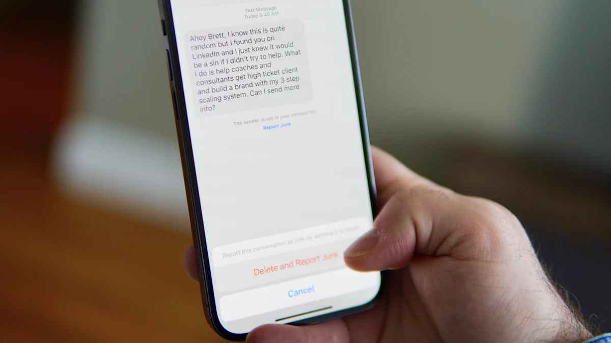 Hand holding a smartphone showing a text message conversation